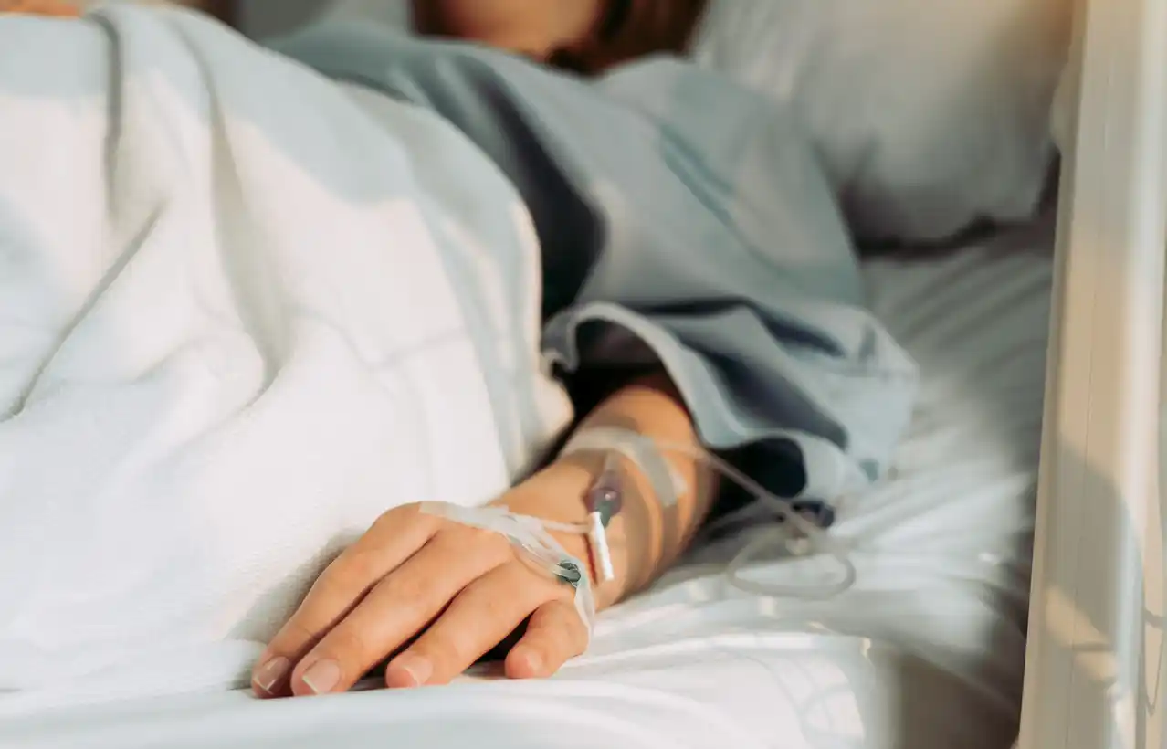 Malpractice Lawyers in Missouri section A person laying in a hospital bed with an IV in their arm
